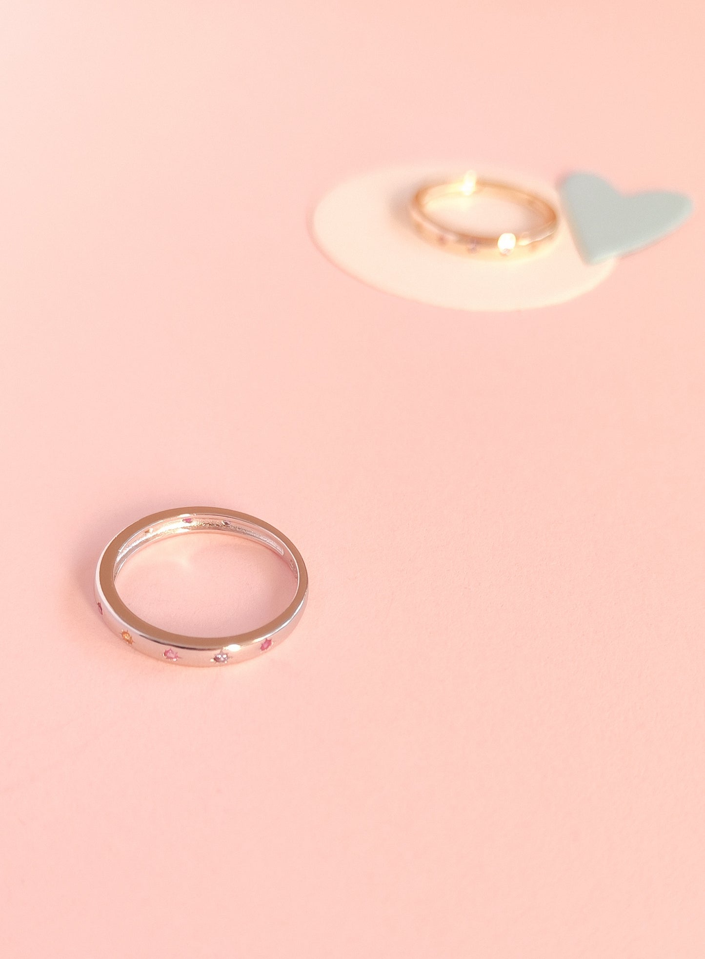 Gold ring on a pink background