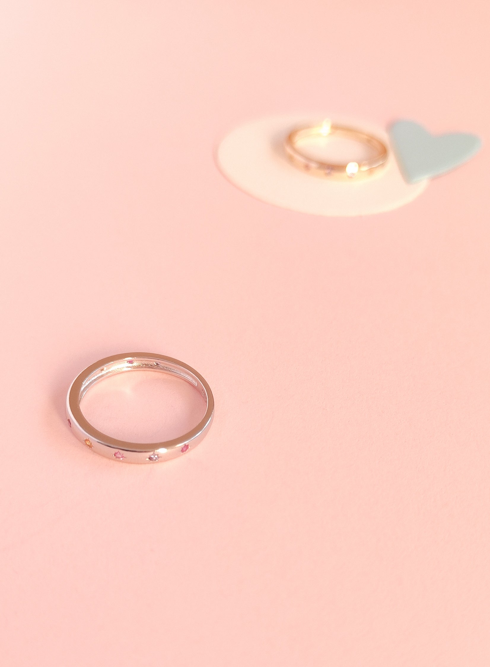 Gold ring on a pink background